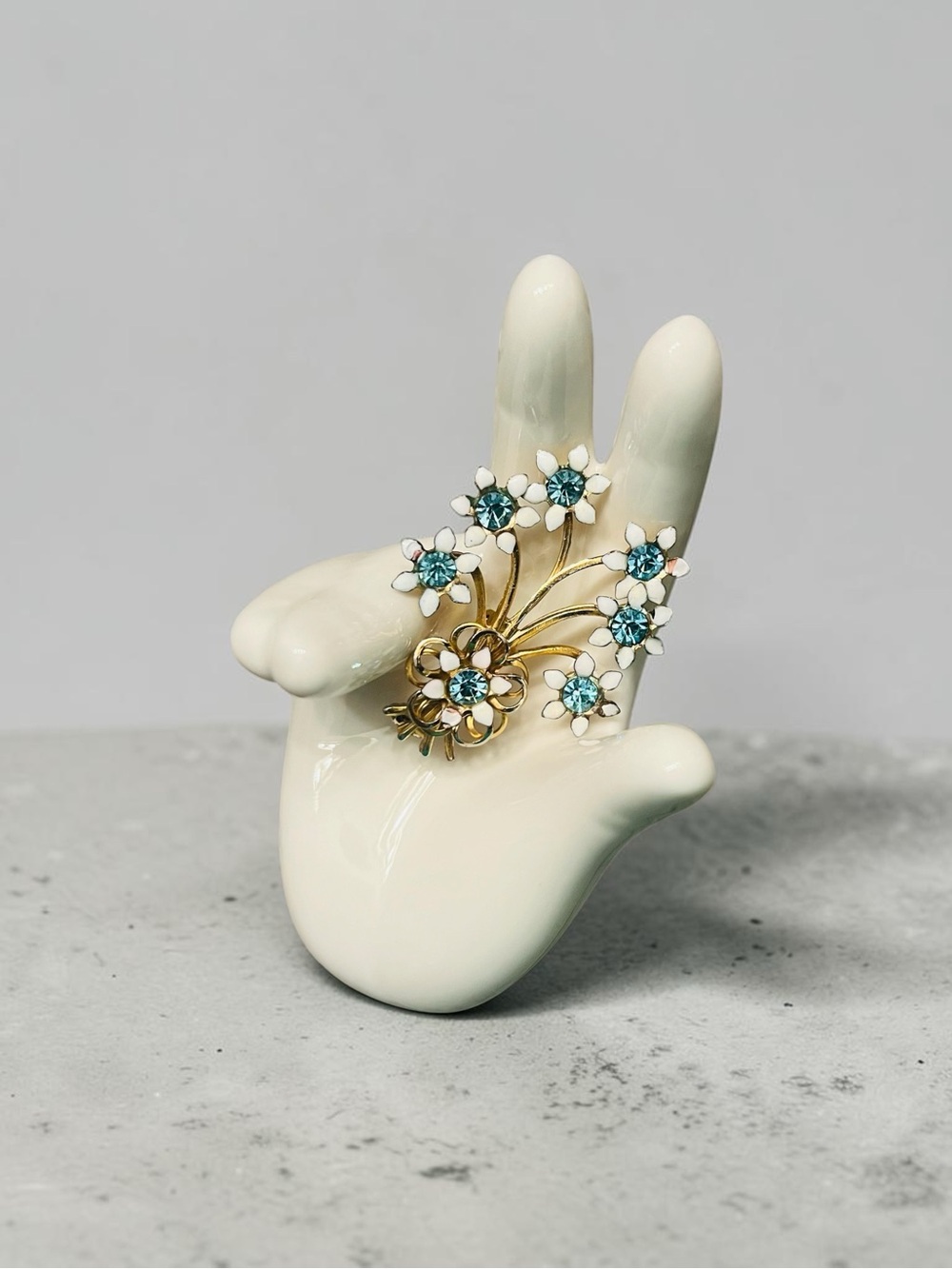 Gold-Tone Floral Spray White Enamel and Blue Rhinestone Brooch